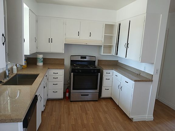 Updated kitchen with stone counters. Stainless steel sink, lots of cabinet space