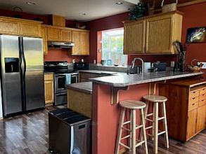 Fully stocked kitchen with new dishwasher.