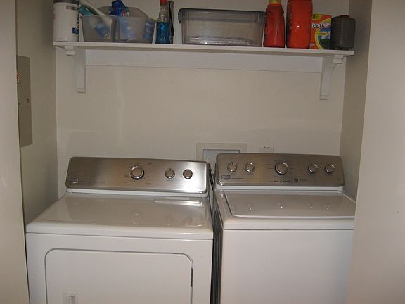 washer and dryer in closet off kitchen