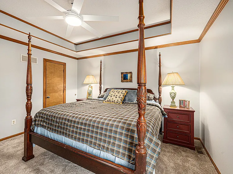 Relax in a well-appointed bedroom where bedside tables and lamps add warmth, comfort, and convenience to the sleeping area.