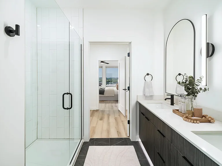 A sleek primary bath at Modera Nations in Nashville showcases spa-inspired design with the option to choose light or dark finishes to suit your style.