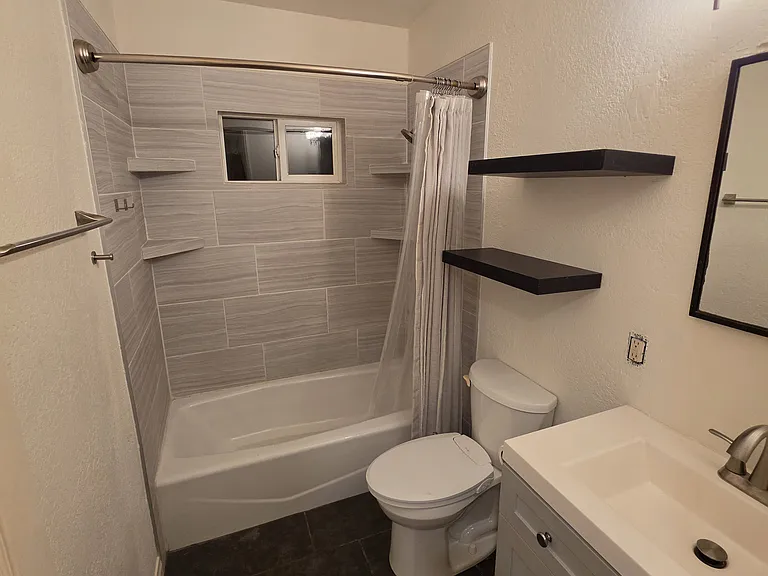 Hallway bathroom with bathtub