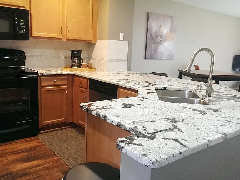 large granite counter top/island & maple cabinets