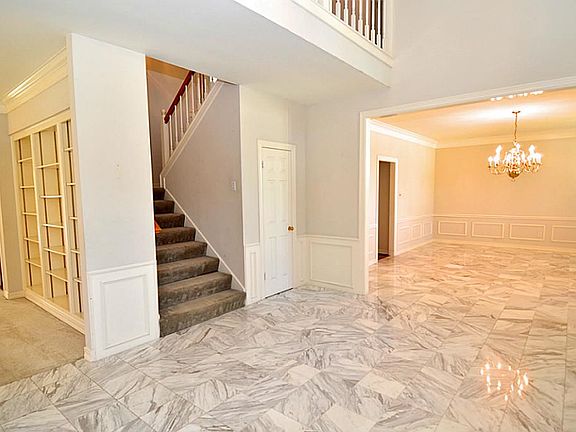  Entry to this home guest will be greeted with marble tile floors in the foyer and formal dining area.