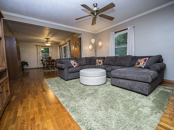 The open living room (14x13) with ceiling fan and crown molding compliment the character of the house.