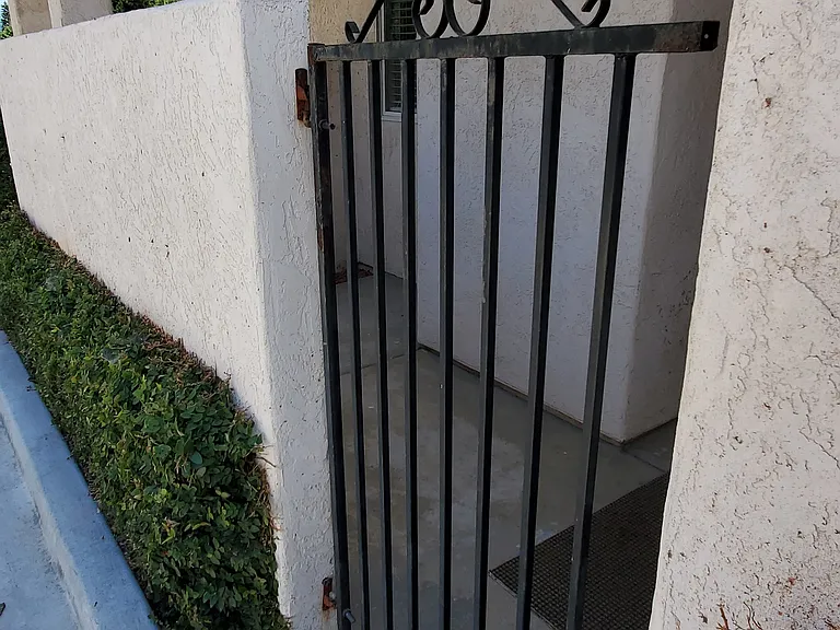 New wrought iron gate to private patio & door entrance
