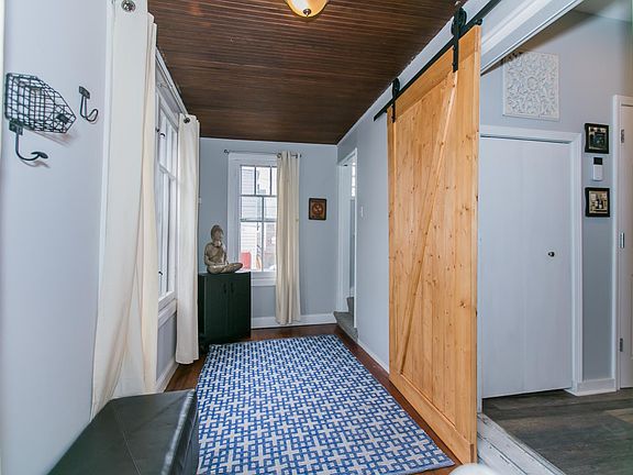 Enclosed sun porch with custom made barn door.