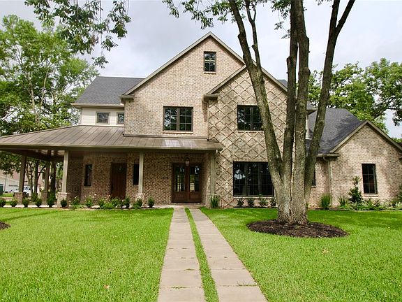 Welcoming front walk up to corner wrap around front porch. Stained porch ceiling has recessed cans and is pre-wired for speakers.