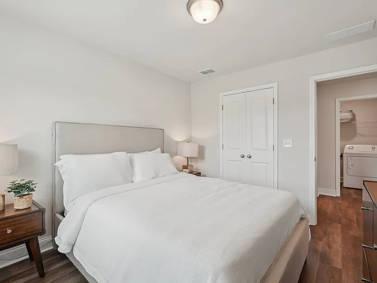 Secondary bedroom with queen size bed and large window letting in a ton of natural light.
