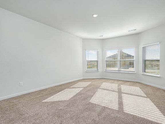 The master bedroom has three large windows that let in great, natural light.