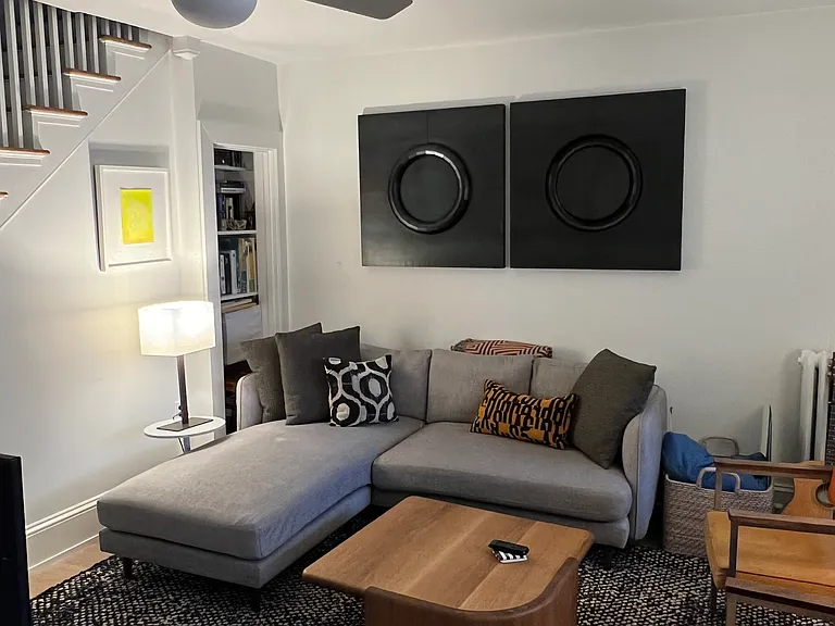 Freshly painted living room with modern ceiling fan.