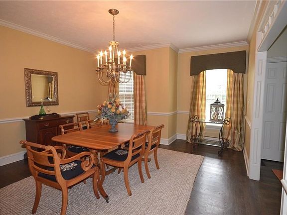 Formal Dining Room features hardwood floors, crown molding and chair rail.