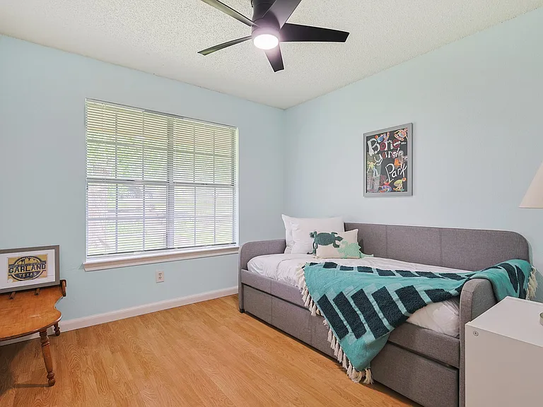 Bedroom 3 - a trundle bed with a large window allowing lots of light into the room.