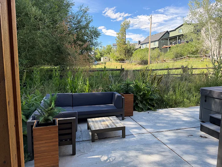 Back patio with seating area and hot tub