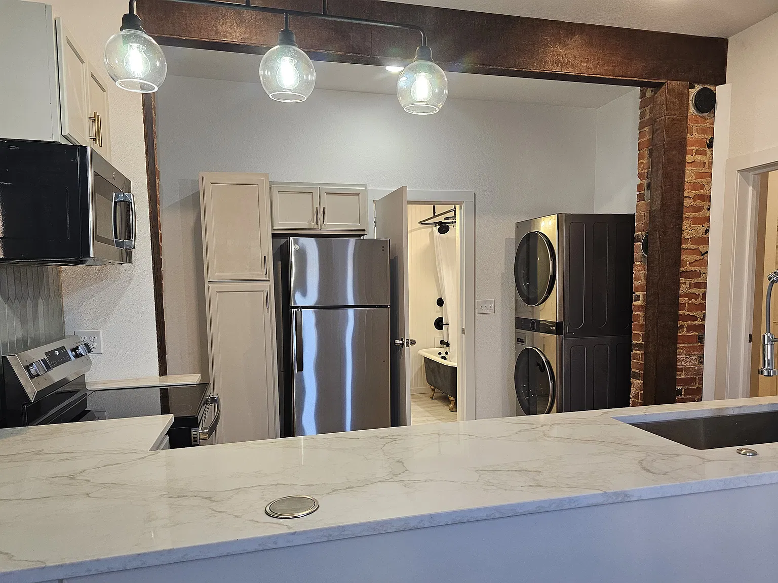 Brand new stainless appliances including full-sized washer and dryer