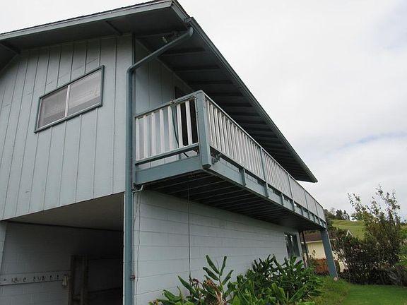 porch runs the length of the unit; sliding glass doors in living room and front bedroom open to porch
