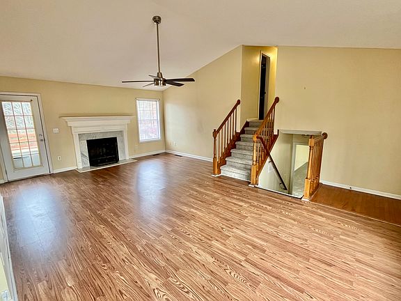 Steps to upper level with 3 BR/2BA, steps down to play/media room, additional bonus office, and laundry.