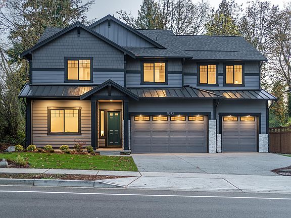 Exterior Dusk Setting. 3-car garage with garage door openers!