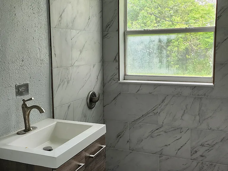 Modern tiled bathroom with floating vanity