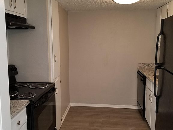 Granite counter-tops and black appliances. 
