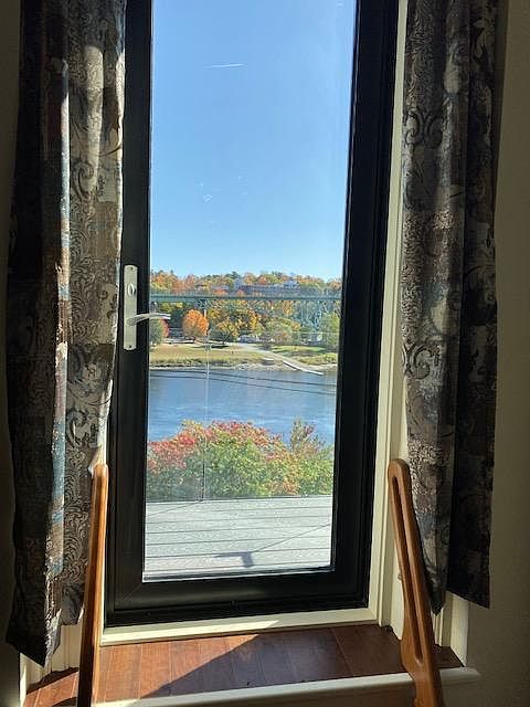 Door, in living room, to balcony and river view.