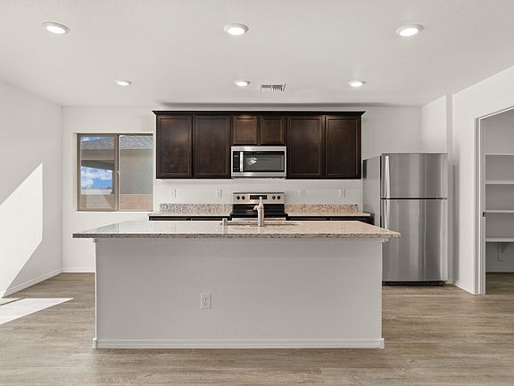 Upgraded kitchen with a breakfast area and walk-in pantry attached.
