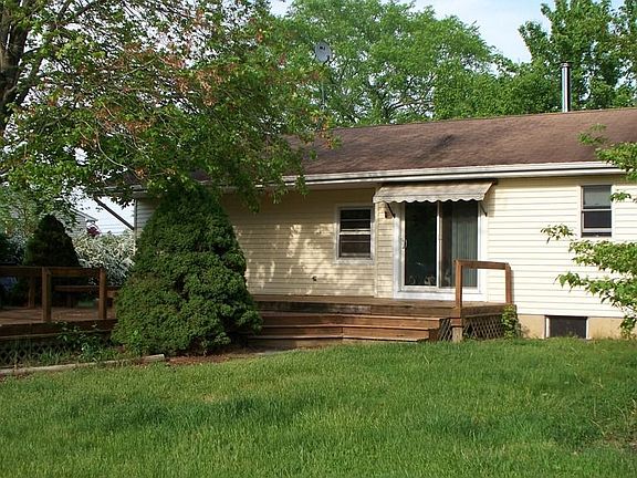 Back of home with two-tiered deck