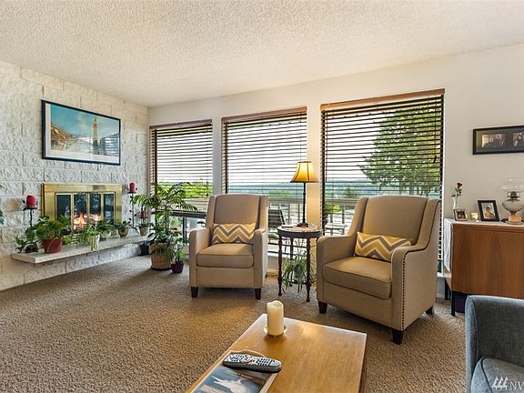 Living room with wood burning fireplace and views of the Bay! 