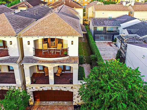 This aerial view shows that the home is on a much larger than normal lotâ35 feet wide instead of 25âgiving it not only a generous side yard and patio, but also an expansive, welcoming entryway. It also has large balconies on the second and third 