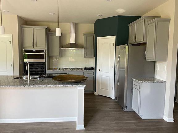 Gourmet kitchen with granite countertops and pantry.
