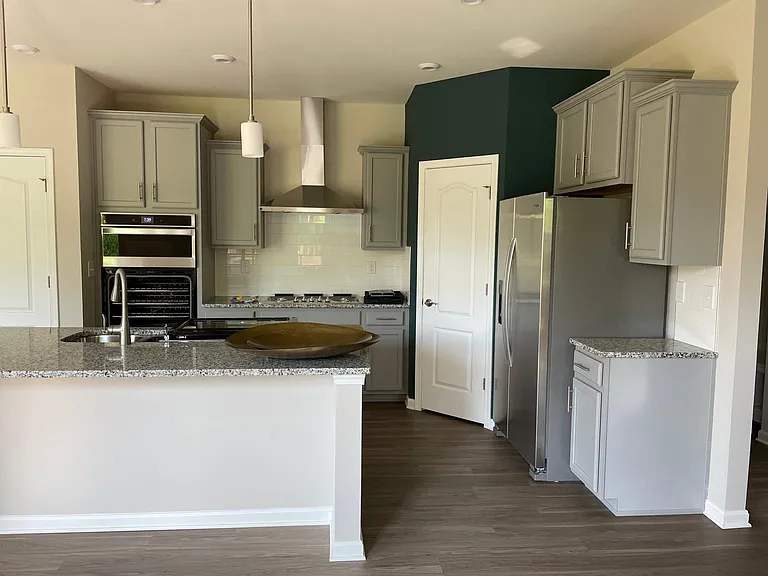 Gourmet kitchen with granite countertops and pantry.