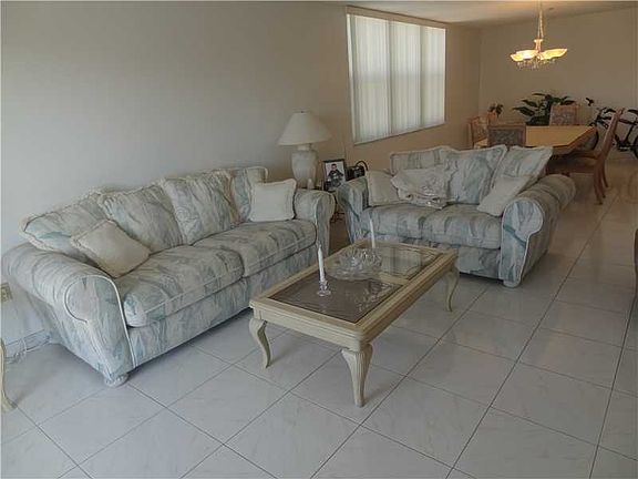 PANORAMIC WATER VIEWS FROM THIS 2BED/2BATH CORNER UNIT STEPS FROM THE BEACH