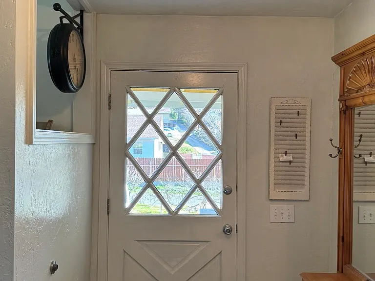 Entry with a laundry room across from the front door. Upon entering, the kitchen is to the left, living room to the right