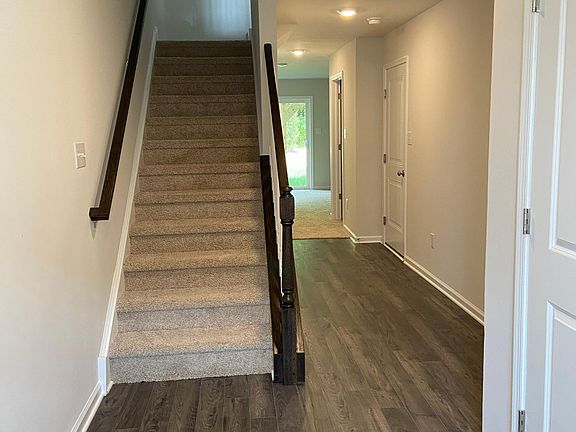 Entrance, hallway leading to recreation room and stairs leading to the second floor.