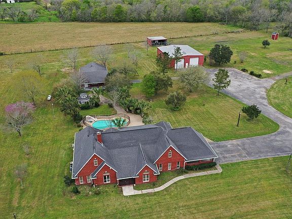 In addition to the home on the almost 15 acres the property boasts a sparking Pool, a Party Barn with a bath, shower, and Third Car Garage space. In addition there is a Storage unit with 2 Garages Doors and space for more vehicles, machinery, and sto