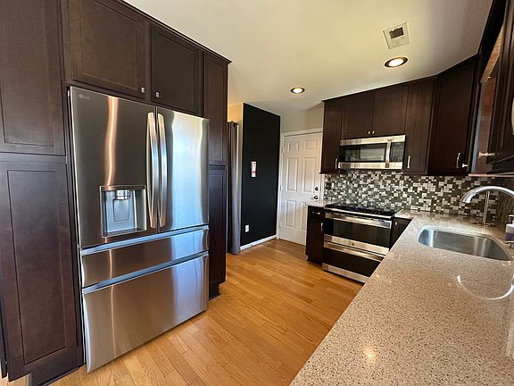 Timeless kitchen with quartz countertops, stainless steel appliances and lots of cabinet storage