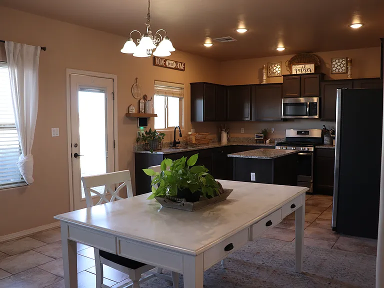 overall of door to the backyard, dining room, and kitchen.