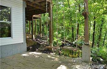 Porch swing overlooking Japanese Koi fish pond.