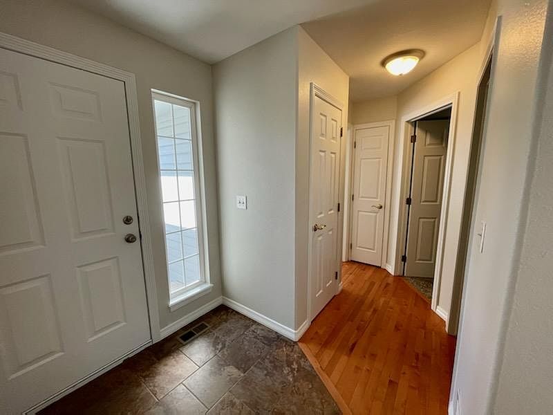 Front door and front hall leading to two front bedrooms and guest bath