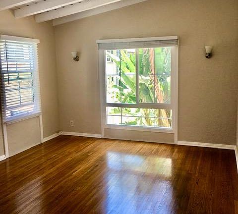Living room is big and bright with Impressive beam ceilings.