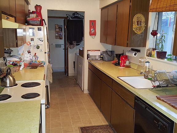 Kitchen, Laundry room, half bath (from near to far) (Note: furnishings belong to a prior tenant; unit will be rented unfurnished)