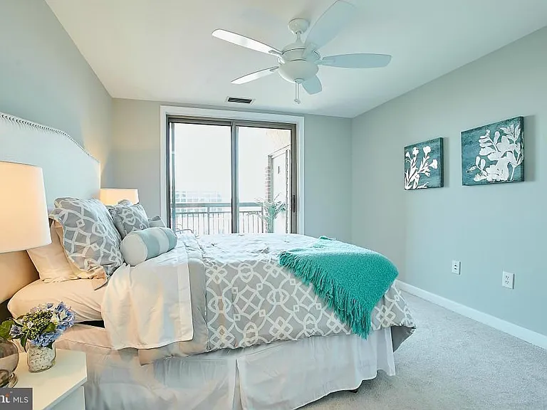 Sunny floor to ceiling sliders in bedroom provides access to balcony. 2nd doorway access is in living room.