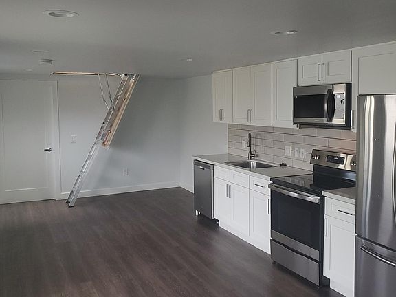 The living/dining/kitchen is undivided, with access to the attic bonus room.
