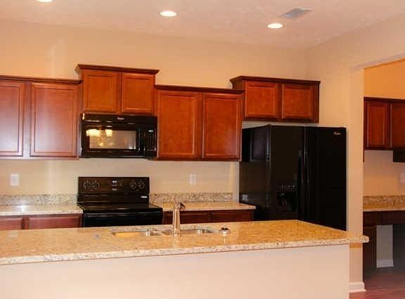 Oversized work space in the kitchen, featuring double bowl stainless sink in the island, staggered