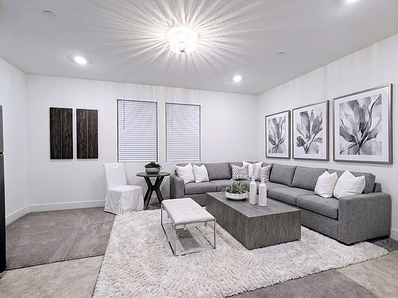 Spacious and versatile living area with upgrade light feature. This room easily accommodates a full-size sectional sofa and a dining table, offering the perfect setup to relax, work, or entertain in style. Your blank canvas for creating your ideal home.