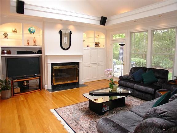 Family Room with hardwood floors overlooking private back yard setting.