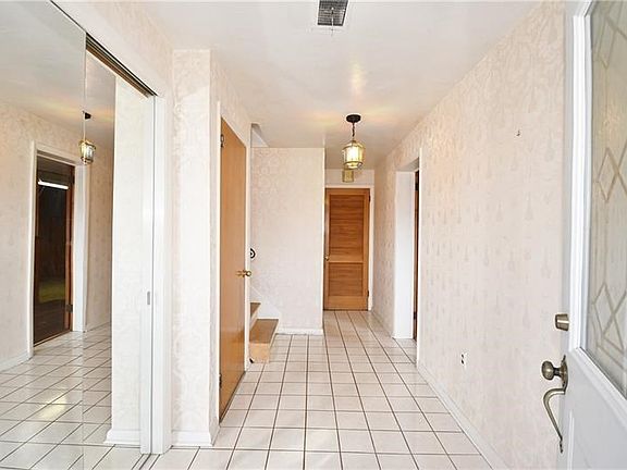 The bright entrance welcomes you into this warm and inviting home. Spacious closet with sliding mirrored doors.
