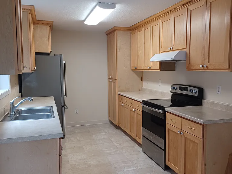 Kitchen area with pantry and cabinet storage areas