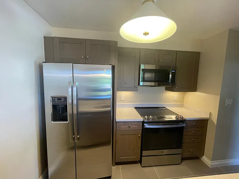 Kitchen with large side-by-side refrigerator, water and ice dispencer