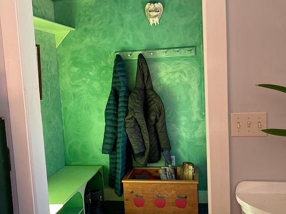 Playful entrance makes a whimsical entrance to the home. Built in shelves, cupboards and bench make the little mudroom an easy spot to drop your gear. Woodbox safely stores wood for the woodstove and keeps the living room clean.